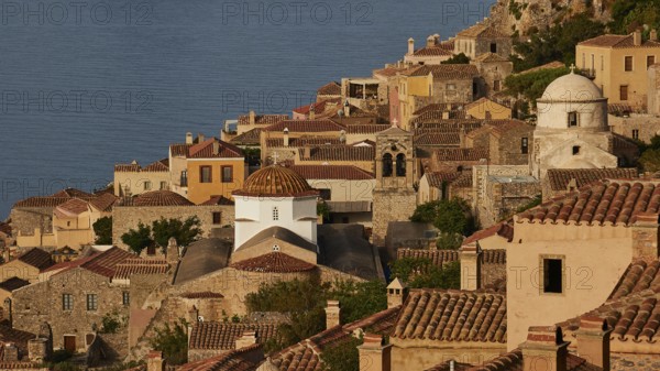 Soft morning light, Holy Church of Christ in Chains, Elkomenos Christos, Classic coastal town with tiled roofs and churches, bathed in warm sunlight, Monemvasia, Monemvassia, Malvasy, Byzantine small town, rocky island, fortress, Laconia, Peloponnese, peninsula, Greece