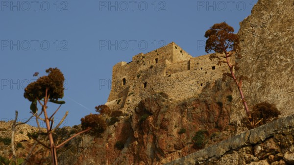 Soft morning light, old stone fortress on rocks with plants, under clear sky, Monemvasia, Monemvassia, Malvasy, Byzantine small town, rocky island, fortress, Laconia, Peloponnese, peninsula, Greece