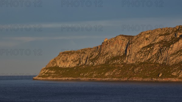Orhodox church of Hagia Sophia, waterside rocks illuminated by evening sun under clear sky, Monemvasia, Monemvassia, Malvasy, Byzantine small town, rocky island, fortress, Laconia, Peloponnese, peninsula, Greece