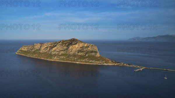 Drone shot, rocky island in calm sea under a blue sky, Monemvasia, Monemvassia, Malvasy, Byzantine small town, rocky island, fortress, Laconia, Peloponnese, peninsula, Greece
