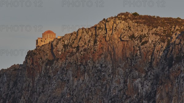 Orhodox church of Hagia Sophia, chapel on bright rock wall in evening light with scenic backdrop, Monemvasia, Monemvassia, Malvasy, small Byzantine town, rocky island, fortress, Laconia, Peloponnese, peninsula, Greece