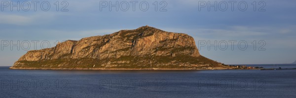 Rocky island in calm water at sunset with blue sky, Monemvasia, Monemvassia, Malvasy, Byzantine small town, rocky island, fortress, Laconia, Peloponnese, peninsula, Greece