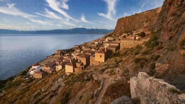 Sky replaced, traditional coastal village with stone houses on a steep rocky coast, Monemvasia, Monemvassia, Malvasy, small Byzantine town, rocky island, fortress, Laconia, Peloponnese, peninsula, Greece
