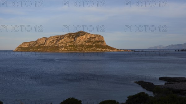 Flat rocky island in the calm blue sea under a clear sky, Monemvasia, Monemvassia, Malvasy, Byzantine small town, rocky island, fortress, Laconia, Peloponnese, peninsula, Greece