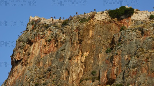 Soft morning light, spectacular cliffs with castle walls and distinct geological layers, Monemvasia, Monemvassia, Malvasy, Byzantine small town, rocky island, fortress, Laconia, Peloponnese, peninsula, Greece