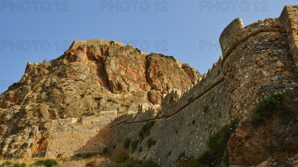 Mighty old city wall wraps around a dramatic rocky landscape, Monemvasia, Monemvassia, Malvasy, small Byzantine town, rocky island, fortress, Laconia, Peloponnese, peninsula, Greece
