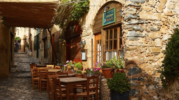 Picturesque restaurant with rustic charm and vibrant plants, Monemvassia, Malvasy, Byzantine small town, rocky island, fortress, Laconia, Peloponnese, peninsula, Greece