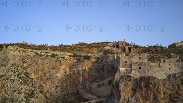 Drone shot, Old rock castle rising above the coastal landscape, Monemvasia, Monemvassia, Malvasy, Byzantine small town, rocky island, fortress, Laconia, Peloponnese, peninsula, Greece