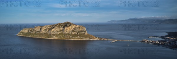 Drone shot, island connected to the mainland by bridge, surrounded by blue water, Monemvasia, Monemvassia, Malvasy, small Byzantine town, rocky island, fortress, Laconia, Peloponnese, peninsula, Greece