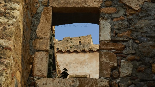 Soft morning light, view through an old window of a ruin with clear blue sky, Monemvasia, Monemvassia, Malvasy, Byzantine small town, rocky island, fortress, Laconia, Peloponnese, peninsula, Greece