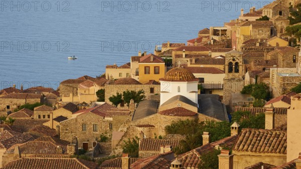 Soft morning light, Holy Church of the Virgin Mary Myrtidiotissa (or Critikias), church tower and historic buildings on the coast with panoramic views and warm light, Monemvassia, Malvasy, small Byzantine town, rocky island, fortress, Laconia, Peloponnese, peninsula, Greece