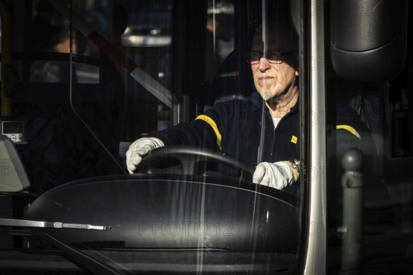 DEU Germany Germany Berlin BVG bus driver wears white gloves to protect against corona. Due to the risk of infection, the driver's door is closed and ticket sales have stopped
