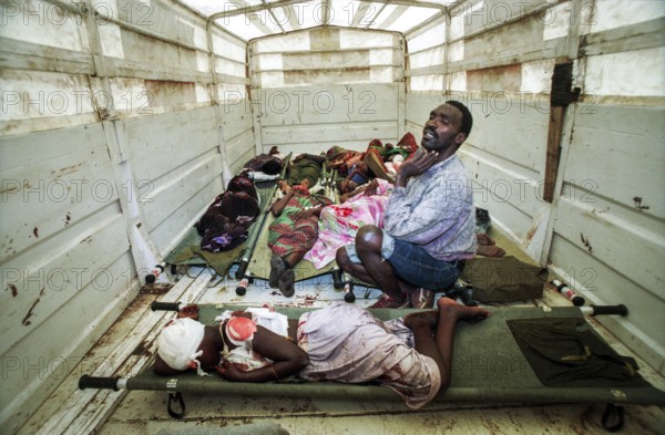 RWA Rwanda Kigali Injured Tutsi refugees who fled to the sports stadium are waiting for treatment in a Red Cross truck. The stadium had previously been attacked with mortar shells by Hutu rebels. RWA Rwanda Kigali Injured Tutsi Refugees Who Escaped the Massacre Waiting in the Back of a Red Cross Truck for Further Treatment They Were Attacked by Hutu Rebels as They Were Hiding in Kigali's Main Sport Stadium