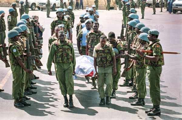 RWA Rwanda Kigali Ghanaian soldiers from the United Nations peacekeeping force UNAMIR carry a killed comrade onto a transport plane at the airport. RWA Rwanda Kigali Ghana Soldiers Carry the Body of a Comrade at the Airport Towards a Plane