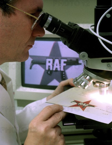 DEU, Wiesbaden, 01.09.1994 -- A BKA official examining an RAF letter for authenticity. -- A police expert proofs a letter of the Red Army Fraction, a German terroristic group, in a laboratory in Wiesbaden. -- © Karsten Thielker