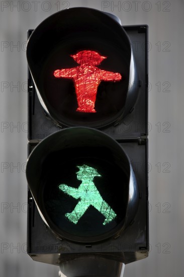 Pedestrian traffic light with red east traffic light man Stoppi and green east traffic light man Galoppo by Karl Peglau, Kult, Berlin, Germany