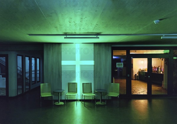 Green illuminated entrance area of the Berlin City Mission at night, Berlin, Germany