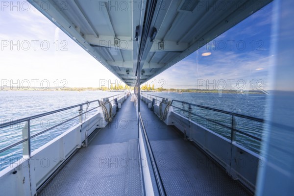Boat trip with window reflection showing the sea on a sunny day, boat trip, Lake Constance, Germany