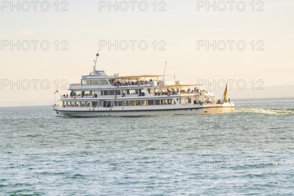 Large passenger ship full of people on calm water under a sunny sky, boat trip, Lake Constance, Germany