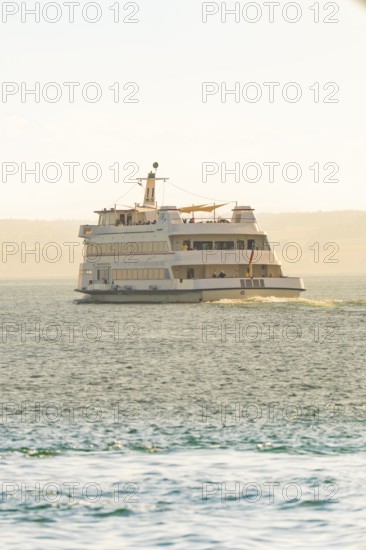 Large ship on calm water with sunny horizon, boat trip, Lake Constance, Germany