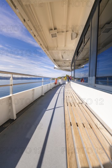 Empty ship deck with sea view under clear blue sky, boat trip, Lake Constance, Germany