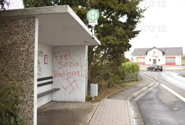 DEU Caan National Socialist graffiti on the wall of a bus stop in Caan, a village near the city of Neuwied. In the background, the firefighting equipment shed. Germany Caan Nazi Graqfittis at a bus stop in the little village Caanm a town 25 km from Koblenz