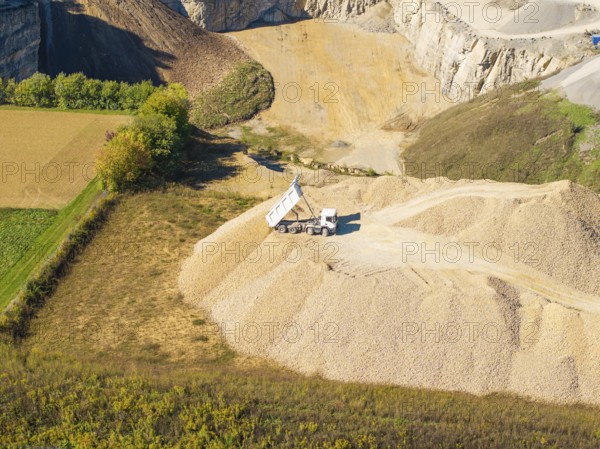 A dump truck seen from the air on a pile of sand near a quarry, Nagold, Black Forest, Germany