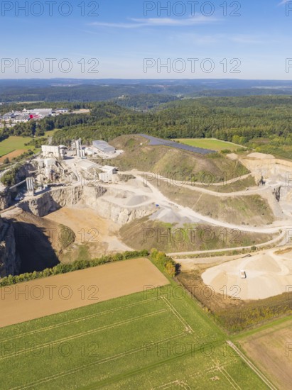 A quarry in a green landscape with forest and cultivated fields, Nagold, Black Forest, Germany