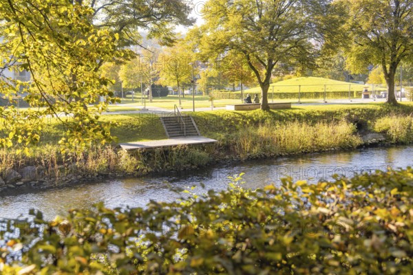 Autumn park on the river with a jetty and trees, Nagold, Black Forest, Germany