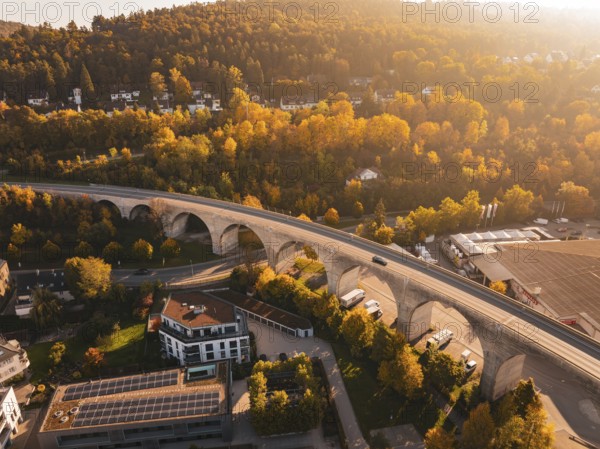 A viaduct in an autumnal landscape, surrounded by nature and a small village, Nagold, Black Forest, Germany