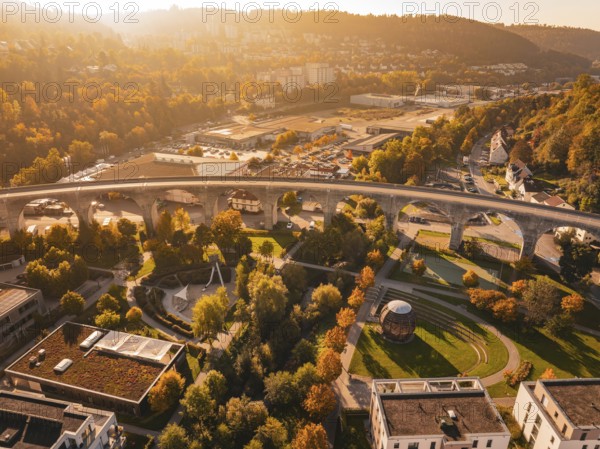 A viaduct in an autumn urban landscape, surrounded by buildings and parks, Nagold, Black Forest, Germany
