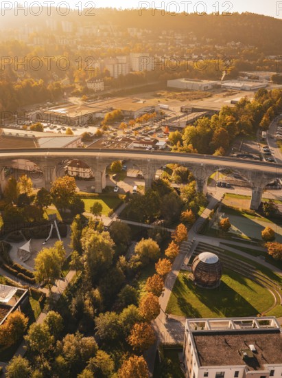 A viaduct spans a city characterized by autumn colors and various buildings, Nagold, Black Forest, Germany