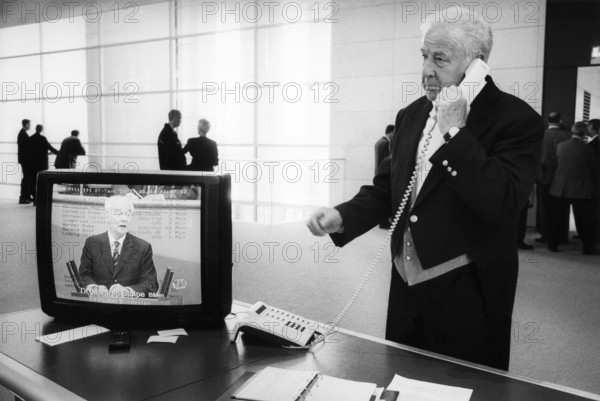DEU, Germany, Berlin, 09.10.2003, A usher in the Reichstag on the phone while Transport Minister Manfred Stolpe speaks in the plenary hall
