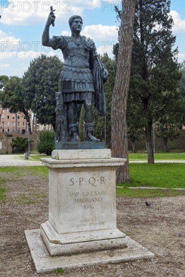 Statue of Emperor Hadrian on pedestal with inscription IMP for Emperor CAESARI HADRIANO AVG abbreviation for Augustus behind Castel Sant'Angelo Mausoleum Hadrian, Rome, Lazio, Italy