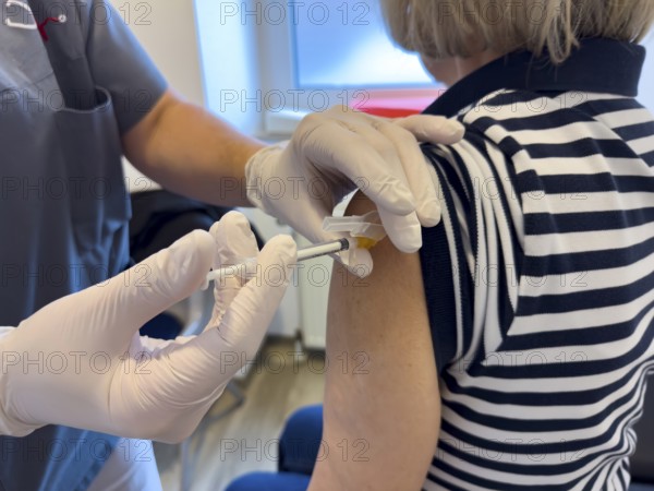 Patient woman receives injection in upper arm for vaccination against contagious disease flu flu vaccination flu protection against influenza virus influenza infections, corona corona vaccination corona protection corona protection coronavirus protection coronavirus, international