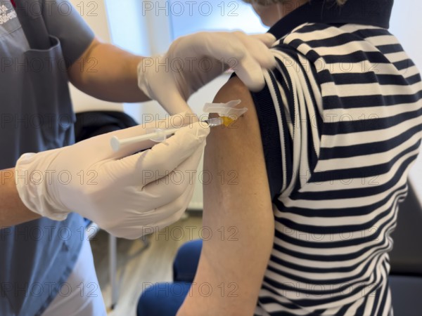 Patient woman receives injection in upper arm for vaccination against contagious disease flu flu vaccination flu protection against influenza virus influenza infections, corona corona vaccination corona protection corona protection coronavirus protection coronavirus, international