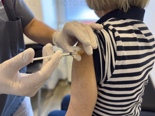 Patient woman receives injection in upper arm for vaccination against contagious disease flu flu vaccination flu protection against influenza virus influenza infections, corona corona vaccination corona protection corona protection coronavirus protection coronavirus, international