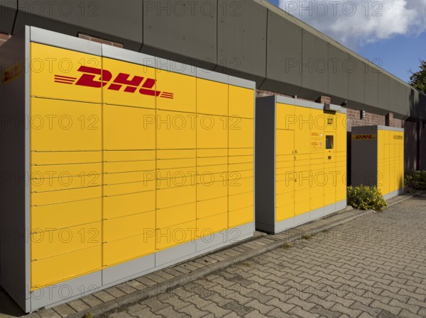 Large DHL packing station in typical yellow color with red logo, Germany