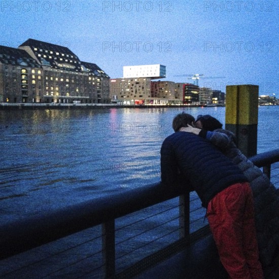 DEU Germany Germany Berlin A couple on the banks of Watergate, a club on the Oberbaum Bridge