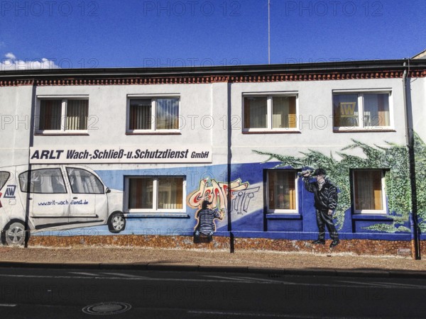 DEU Germany Germany Leipzig Wall painting as an advertisement for a security company in Leipzig
