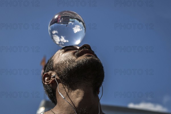 DEU Germany Germany Berlin Juggler with crystal ball works at the intersection opposite the CDU federal party headquarters