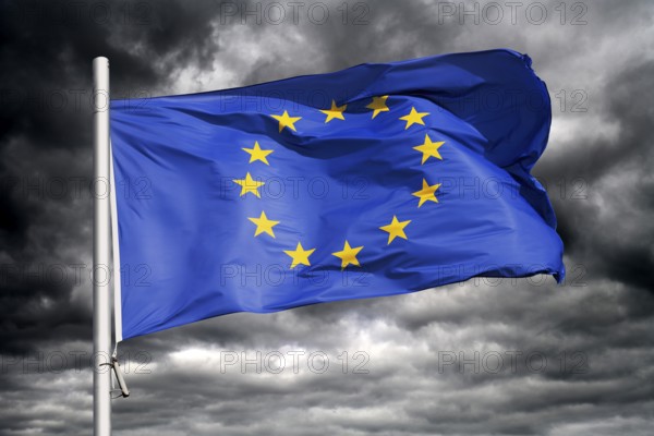 European Union flag waving against dark sky, photo montage