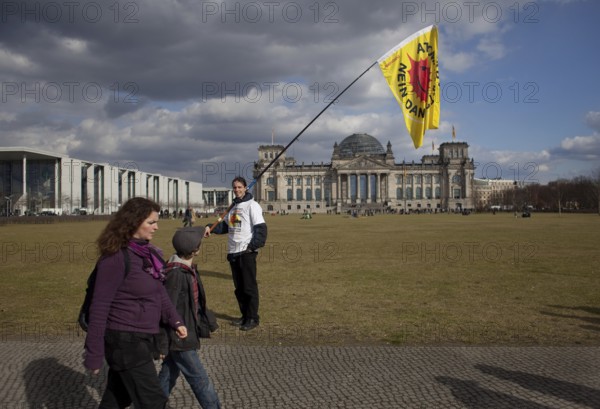 Germany Berlin Anti-nuclear power demonstration in Berlin Mitte. A demonstrator in front of the Reichstag Germany Berlin protest rally against nuclear power plants. A protester in front of the Reichstag, the German Parliament