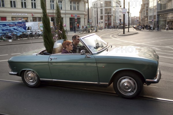 DEU Berlin convertible with plants on Rosenthaler Straße in Berlin Mitte Germany Berlin convertible car with plants on the backseat enters Rosenthaler Straße in Berlin Mitte