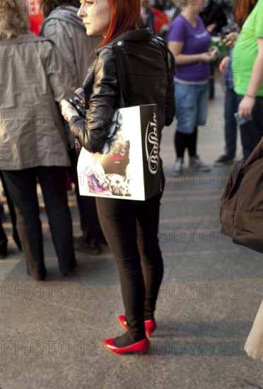 DEU Berlin woman with red shoes on Rosenthaler Straße in Berlin Mitte Germany Berlin Woman in red shoes strolls along Rosenthaler Straße in Berlin Mitte
