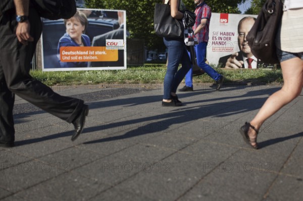 DEU Germany Germany Berlin Pedestrians pass the election posters of Angela Merkel CDU and Peer Steinbrück SPD