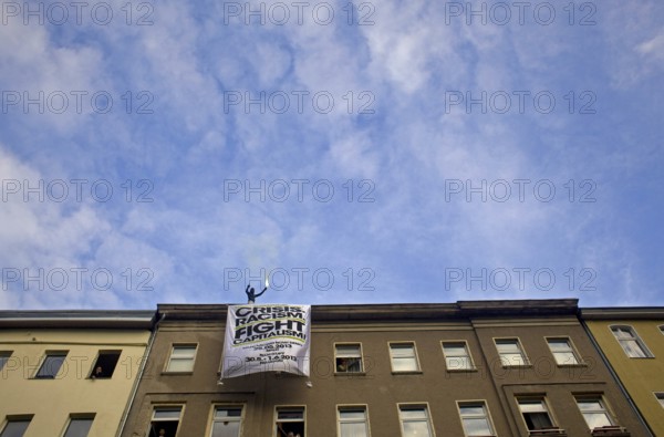 GERMANY Demonstrator with Bengali fire at the May 1 rally in Kreuzberg. Germany Berlin Protester on the roof of a house during the May Day Protest