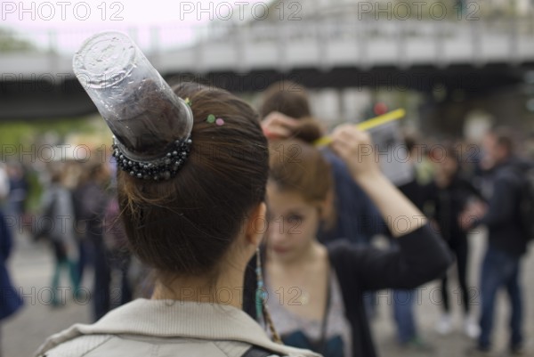 GERMANY A woman with a plastic cup as a fashionable hairstyle at the May 1 rally in Kreuzberg. Germany Berlin A woman with fancy hairdress during the May Day Protest