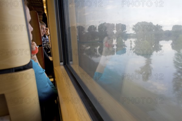 DEU Wittenberge Travelers pass through the flood area around the Luther city Witenberge on the ICE train from Munich to Berlin. Germany Wittenberge Passengers riding the ICE train from Munich to Berlin watching the floods in the East German town of Wittenberge