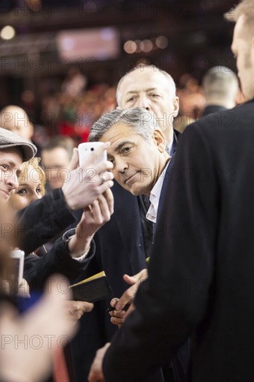 DEU Germany Germany Berlin 64th Berlinale, the international film festival in the German capital. The director of the films 'Monuments Men' George Clooney has himself photographed by a fan with his smartphone